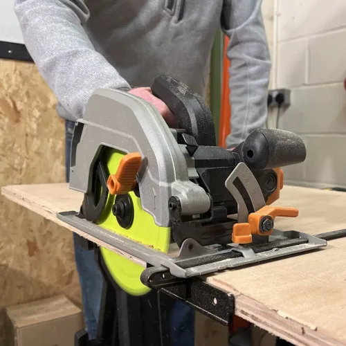man using circular saw blade to cut a laminate worktop