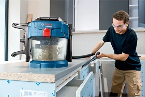 man using a mitre saw dust extraction system