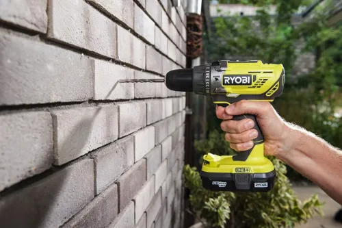 combi drill drilling through a wall