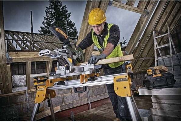 workman using the Dewalt DCS365N mitre saw