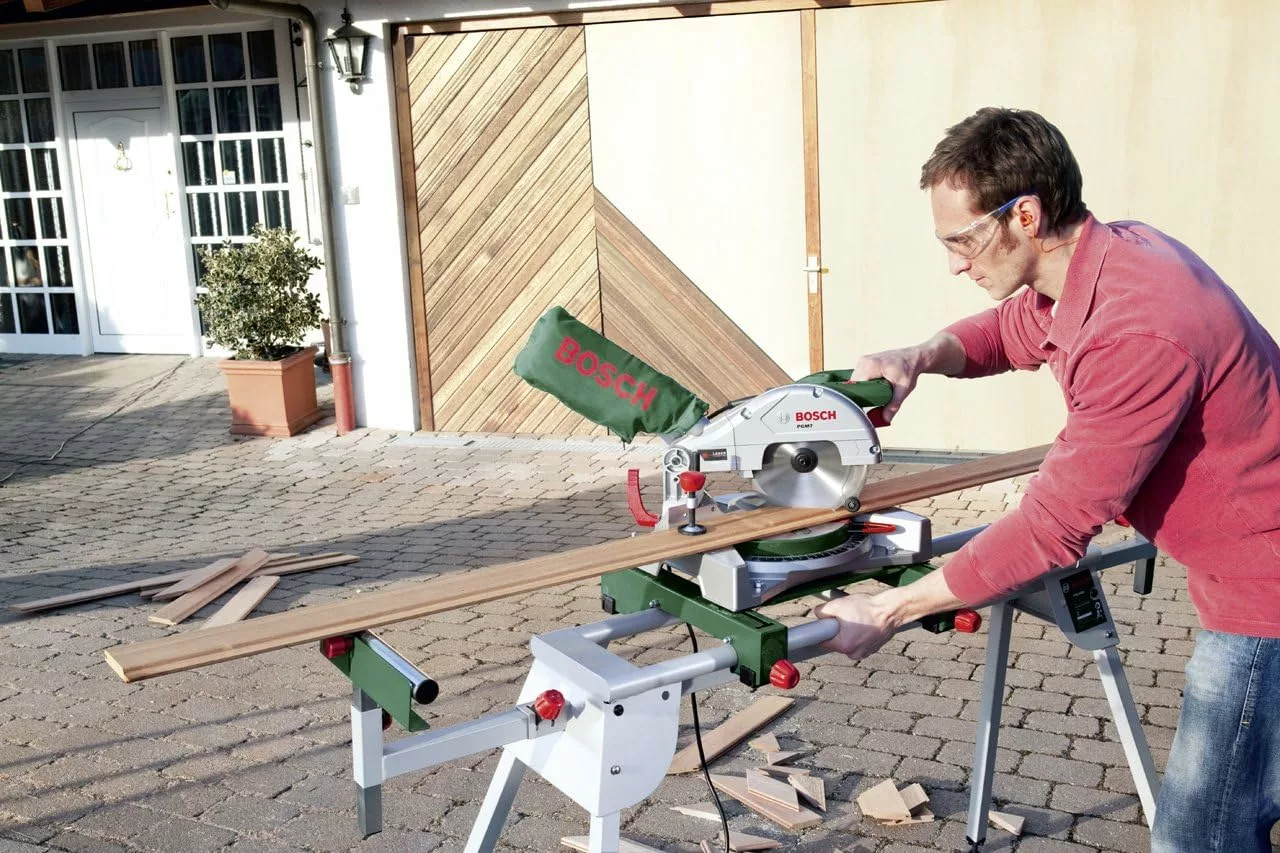 Man Using the Bosch 0603B05000 PTA 2400 Mitre Saw Stand