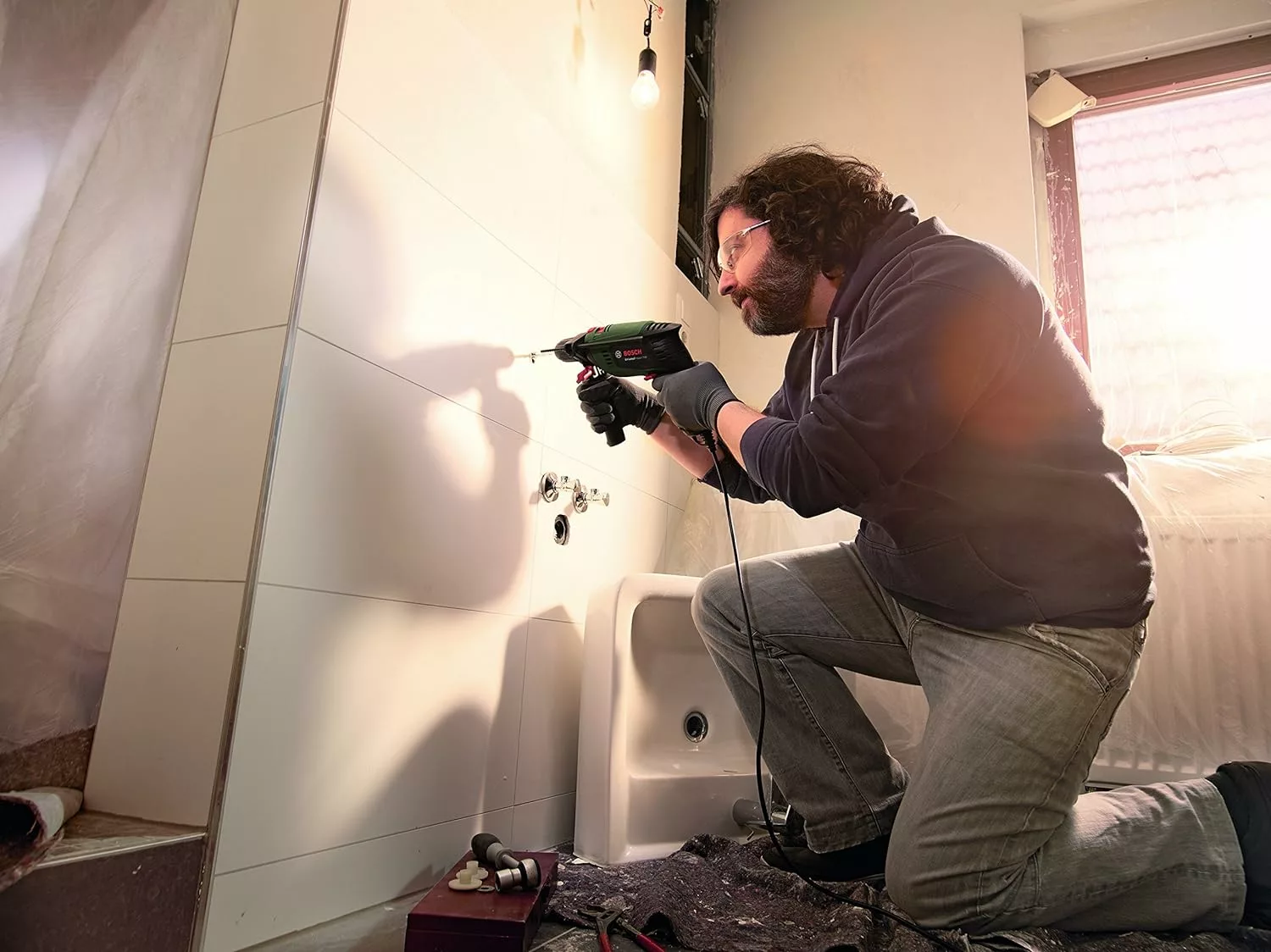 man using a bosch corded drill