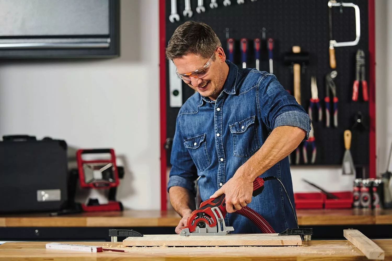 man using the einhell tc-cs 89 mini circular saw