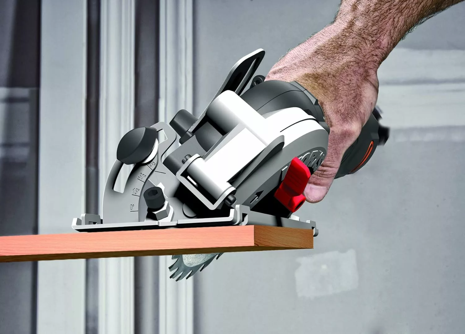man making a bevel cut using the worx wx439 mini circular saw