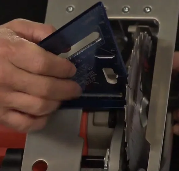 man using a square to align the blade of a circular saw