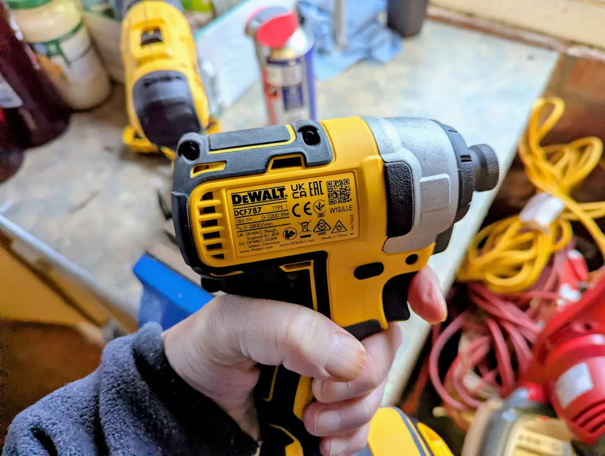Enda holding his DCF787N impact driver in his garage