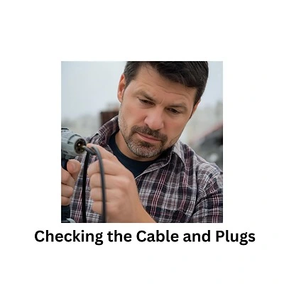 man checking the cable and plug on a corded drill