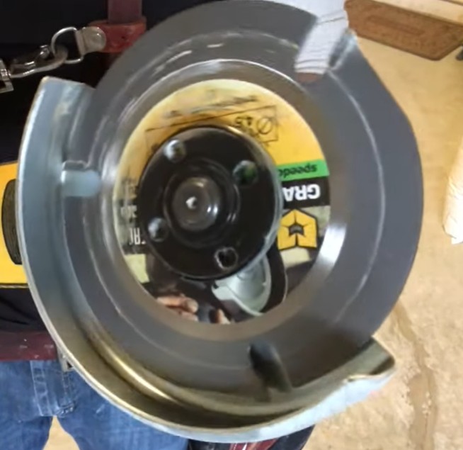 bottom of angle grinder with an attached multi-material blade