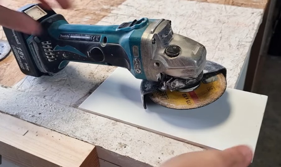 angle grinder sitting on top of a tile