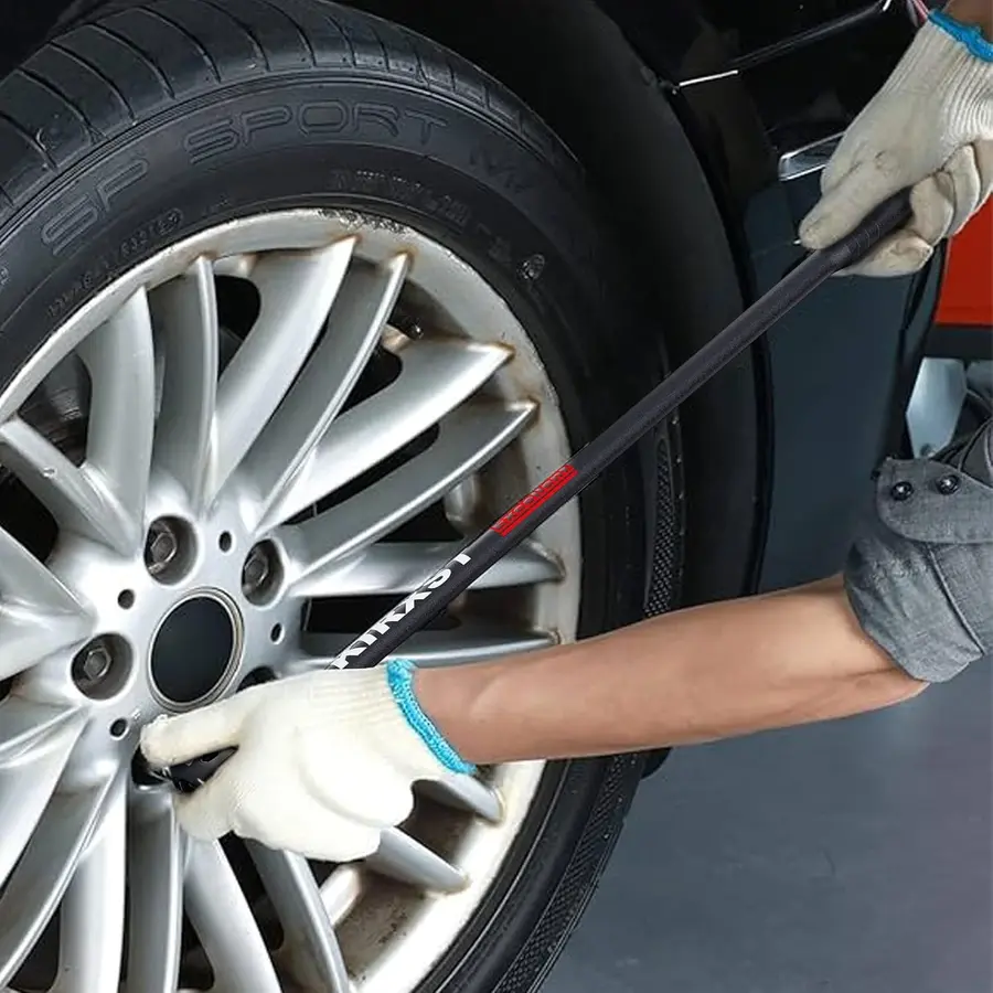 breaker bar being used to loosen wheel nuts on a car